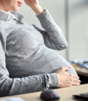 Pregnant employee looking stressed