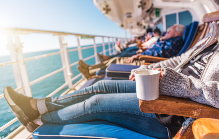 Elderly people laid on deck chairs of cruise ship